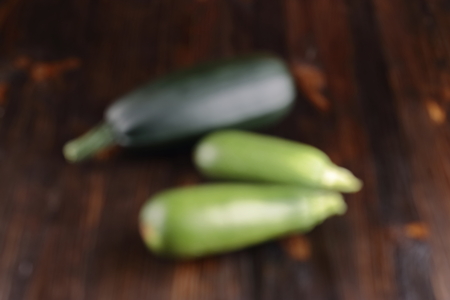 Courgettes on a wooden background. Out of focus.の写真素材