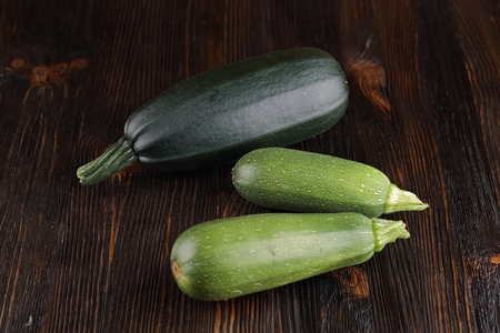 Courgettes on a wooden background.の写真素材