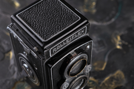 MOSCOW, RUSSIA, MAY 28, 2017. The old German medium-format TLR camera Rolleiflex, released1938 on lava background. Rolleiflex Automat 6x6 - Model RF 111A.のeditorial素材