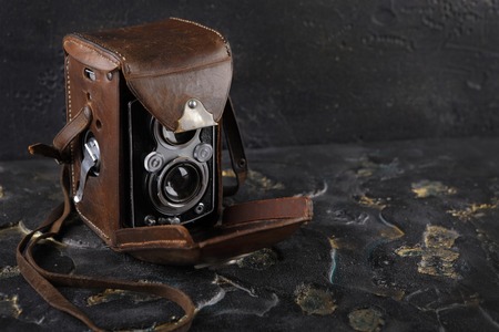 The old medium-format TLR camera on lava background.の写真素材