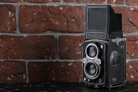 MOSCOW, RUSSIA, JUNE 2, 2017. The old German medium-format TLR camera Rolleiflex, released1938 on brick wall background. Rolleiflex Automat 6x6 - Model RF 111A.のeditorial素材