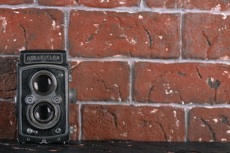MOSCOW, RUSSIA, JUNE 2, 2017. The old German medium-format TLR camera Rolleiflex, released1938 on brick wall background. Rolleiflex Automat 6x6 - Model RF 111A.のeditorial素材