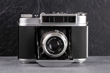 MOSCOW, RUSSIA, SEPTEMBER 12, 2017. The old Soviet medium format rangefinder camera Iskra-2, released1964, on cement background.のeditorial素材
