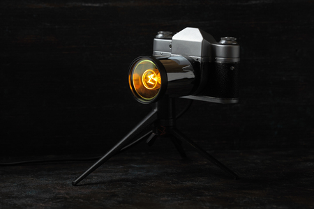 A vintage lamp made by me from an old film camera on a cinnamon cement background.の写真素材