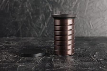 Old lenses on a dark concrete background. Black texture of cement.の写真素材