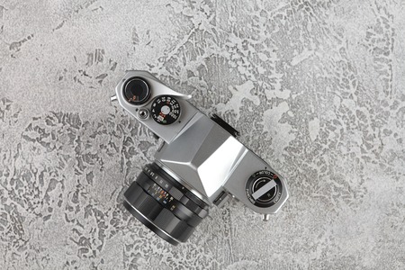 MOSCOW, RUSSIA, JUNE 05, 2018. The old Japan 35 mm SLR camera Asahi Pentax Spotmatik with 55 mm Pentax lens, released 1971 with film packings lford & Kodak on black cement background .のeditorial素材