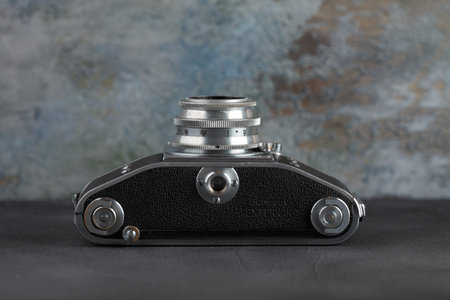 MOSCOW, RUSSIA, JUNE 18, 2018. The old German 35 mm SLR camera Exakta Varex 1950 with lens Victar 1:2,9, released 1950 in in the territory of the former Soviet occupied Germany on a grey cement wall.のeditorial素材