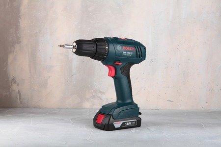 MOSCOW, RUSSIA, AUGUST 30, 2018. 18V Lithium-Ion Cordless Drill/Drivers Bosch GSR 1800-LI against the background of a plastered wall.のeditorial素材