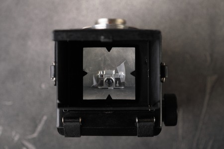 MOSCOW, RUSSIA, FEBRUARY 22, 2019. The first post-war Soviet medium-format scaling camera Komsomolets, copy Voigtlander Brilliant V6, released1949 on grey cement background.のeditorial素材