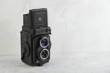 MOSCOW, RUSSIA, MARCH 31, 2019. The old Japan medium format film TLR camera Yashica MAT 124G, released 1971 on white cement background.のeditorial素材