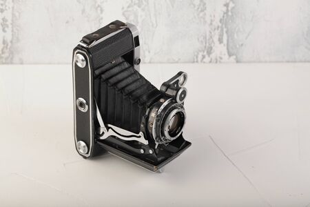MOSCOW, RUSSIA, JULY 02, 2019. Old Soviet medium format rangefinder camera Moskwa-5, released1957 on white cement background. Camera Moskva-5 is oficial copy german film camera Super Ikonta C 531-2.のeditorial素材