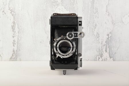 MOSCOW, RUSSIA, JULY 02, 2019. Old Soviet medium format rangefinder camera Moskwa-5, released1957 on white cement background. Camera Moskva-5 is oficial copy german film camera Super Ikonta C 531-2.のeditorial素材