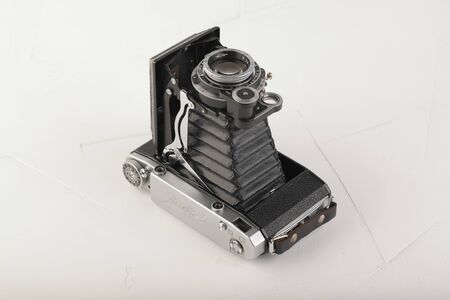 MOSCOW, RUSSIA, JULY 02, 2019. Old Soviet medium format rangefinder camera Moskwa-5, released1957 on white cement background. Camera Moskva-5 is official copy german film camera Super Ikonta C 531-2.のeditorial素材