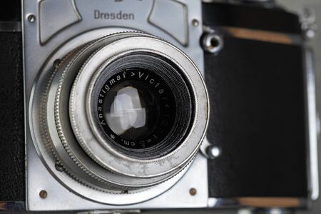 The old German 35 mm SLR film camera Kine Exakta released 1938, with Victar Anastigmat 2,9 50, released 1946, on a gray cement background.のeditorial素材