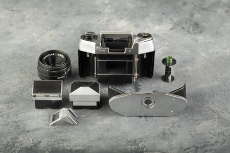 The old German 35 mm SLR camera Exa-1b with lens Domiplan 2,8 50, released 1984 in East Germany on a grey cement background.のeditorial素材