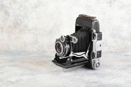 Old Soviet medium format rangefinder camera Moskva-4, released 1956 on gray cement background. Camera Moskva-4 is official copy german film camera Super Ikonta C 531-2.のeditorial素材