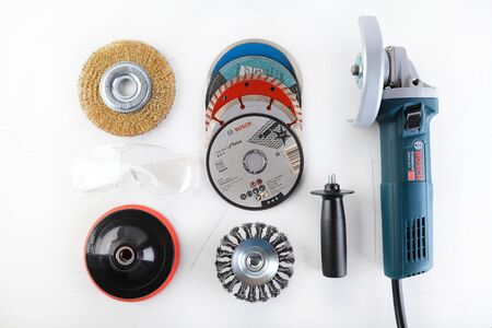 Angle Grinder Bosch GWS 9-125 s on white cement background. Bosch tools.のeditorial素材