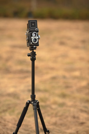 The old Japan medium format film TLR camera Yashica 12, released 1967 in an autumn meadow with withered grass.のeditorial素材