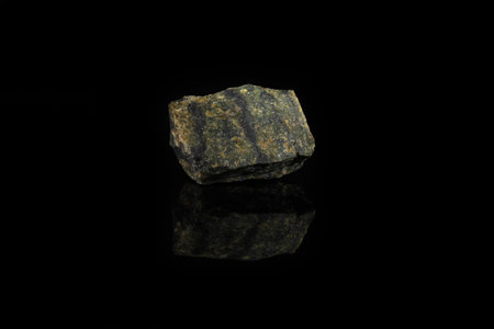 Natural mineral stone - piece of Serpentine, Lizardite gemstone from Bajenovo, Ural, Russia on black...