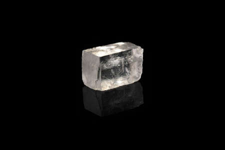 Raw Iceland spar from Krasnoyarsk region, Russia on black glass background.の写真素材