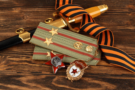 Orders and medals of the veteran on the St. George ribbon. MAY 9 greeting card. Wooden background.
