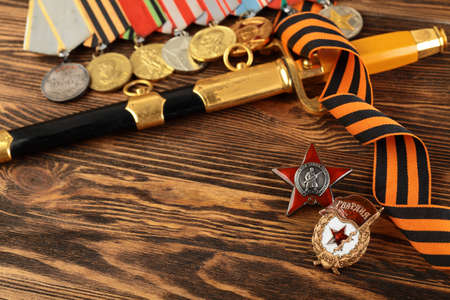 Orders and medals of the veteran on the St. George ribbon. MAY 9 greeting card. Wooden background.の写真素材