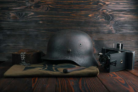 Rusty german army helmet from second world war. The inscription on a medal in the German language - for faithful services in the police.の写真素材