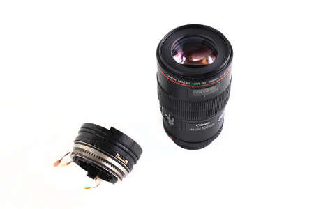 MOSCOW, RUSSIA, FEBRUARY 04, 2022. Very popular macro lens Canon EF 100mm f2.8L Macro USM lens and its autofocus node on a white background.のeditorial素材