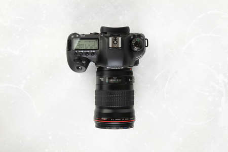DSLR Digital Camera full frame sensor of EOS Canon 5D mark IV with Canon lens EF 135mm f 2L USM on gray white cement background.のeditorial素材