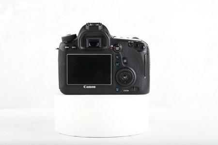 DSLR Digital Camera full frame sensor of EOS Canon 6D on white cement background.