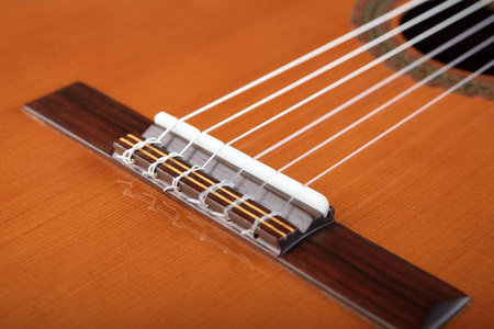 Mahogany classical guitar on vintage background.