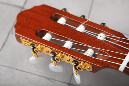 Mahogany classical guitar on vintage background.