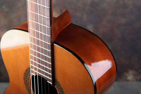 Mahogany classical guitar on vintage background.