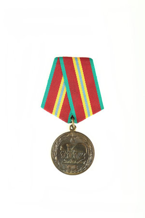 A darkened Soviet military medal "70 years of the Armed USSR" on a white background.の写真素材