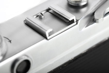 The rare old rangefinder film camera with lens on white background.