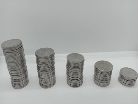 bangladeshi bank note and coin on white background