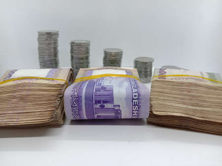 bangladeshi bank note and coin on white backgroundの写真素材