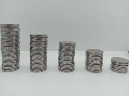 bangladeshi bank note and coin on white backgroundの写真素材