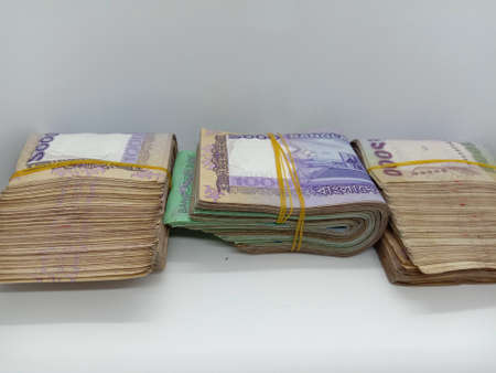 bangladeshi bank note and coin on white backgroundの写真素材