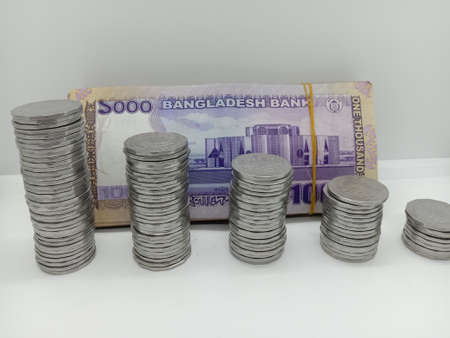 bangladeshi bank note and coin on white backgroundの写真素材
