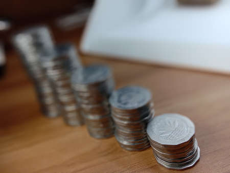 bangladeshi bank note and coin on white backgroundの写真素材