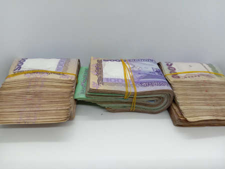 bangladeshi bank note and coin on white backgroundの写真素材