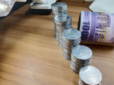 bangladeshi bank note and coin on white backgroundの写真素材