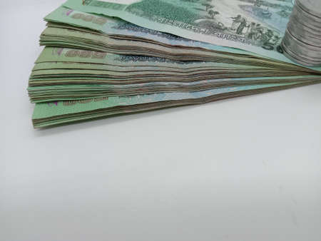 bangladeshi bank note and coin on white backgroundの写真素材