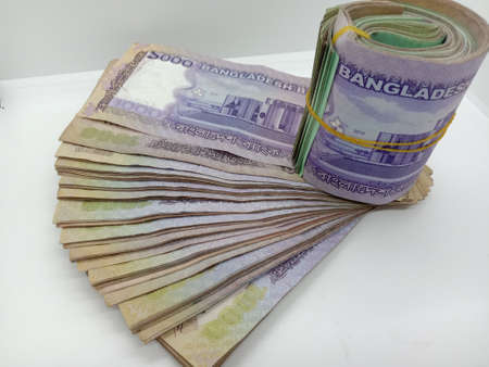 bangladeshi bank note and coin on white backgroundの写真素材