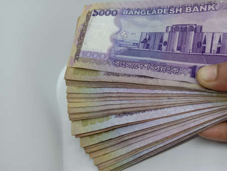 bangladeshi bank note and coin on white backgroundの写真素材
