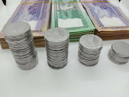 bangladeshi bank note and coin on white backgroundの写真素材
