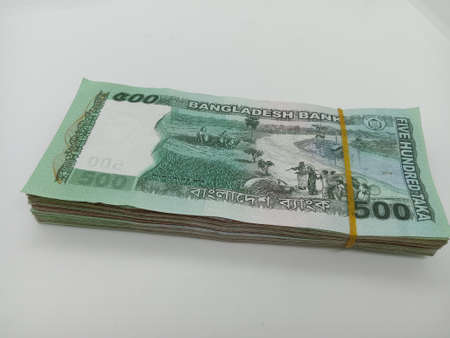 bangladeshi bank note and coin on white backgroundの写真素材