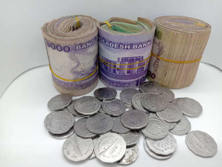 bangladeshi bank note and coin on white backgroundの写真素材