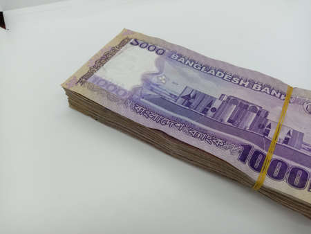 bangladeshi bank note and coin on white backgroundの写真素材